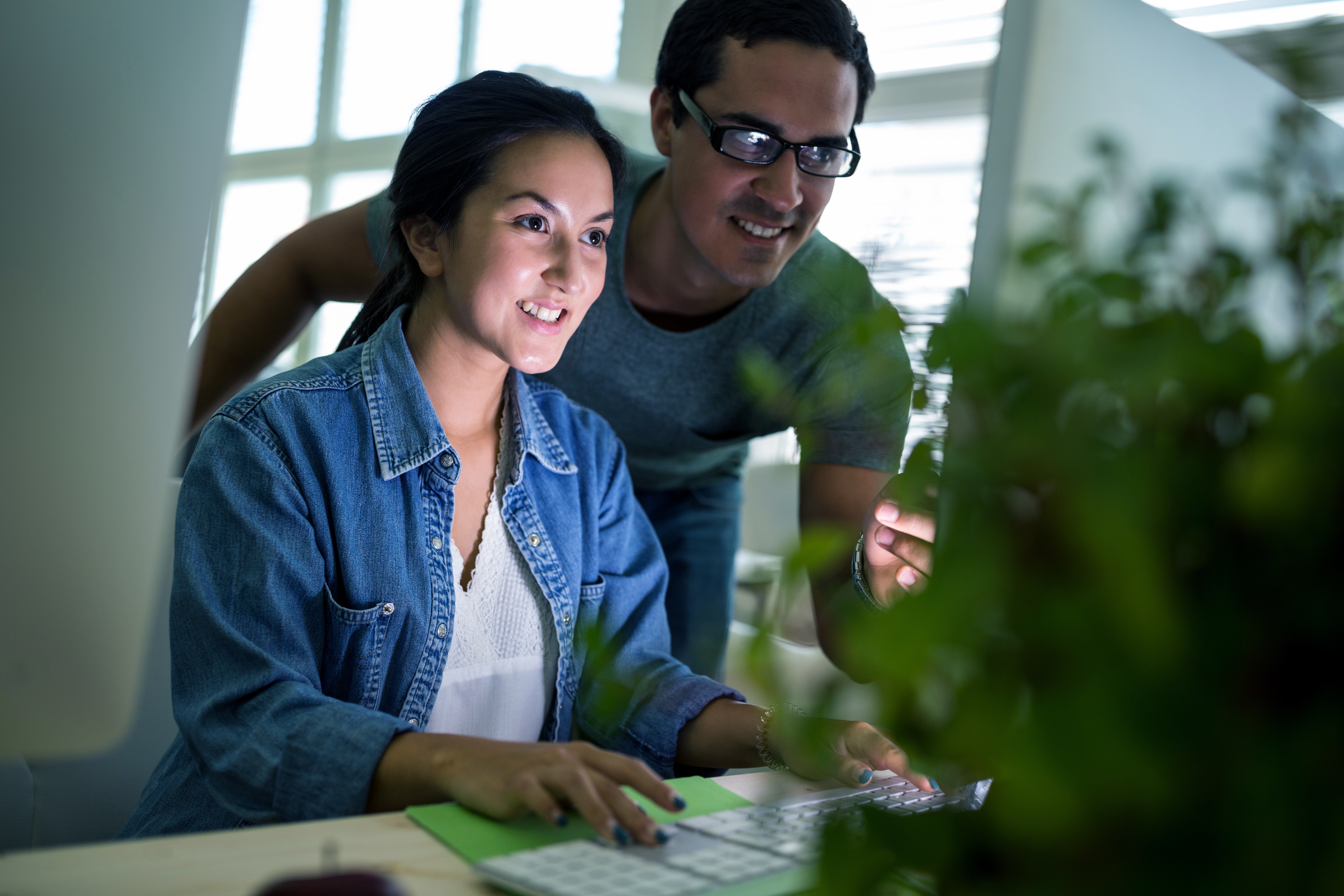 Male and female graphic designers working on computer