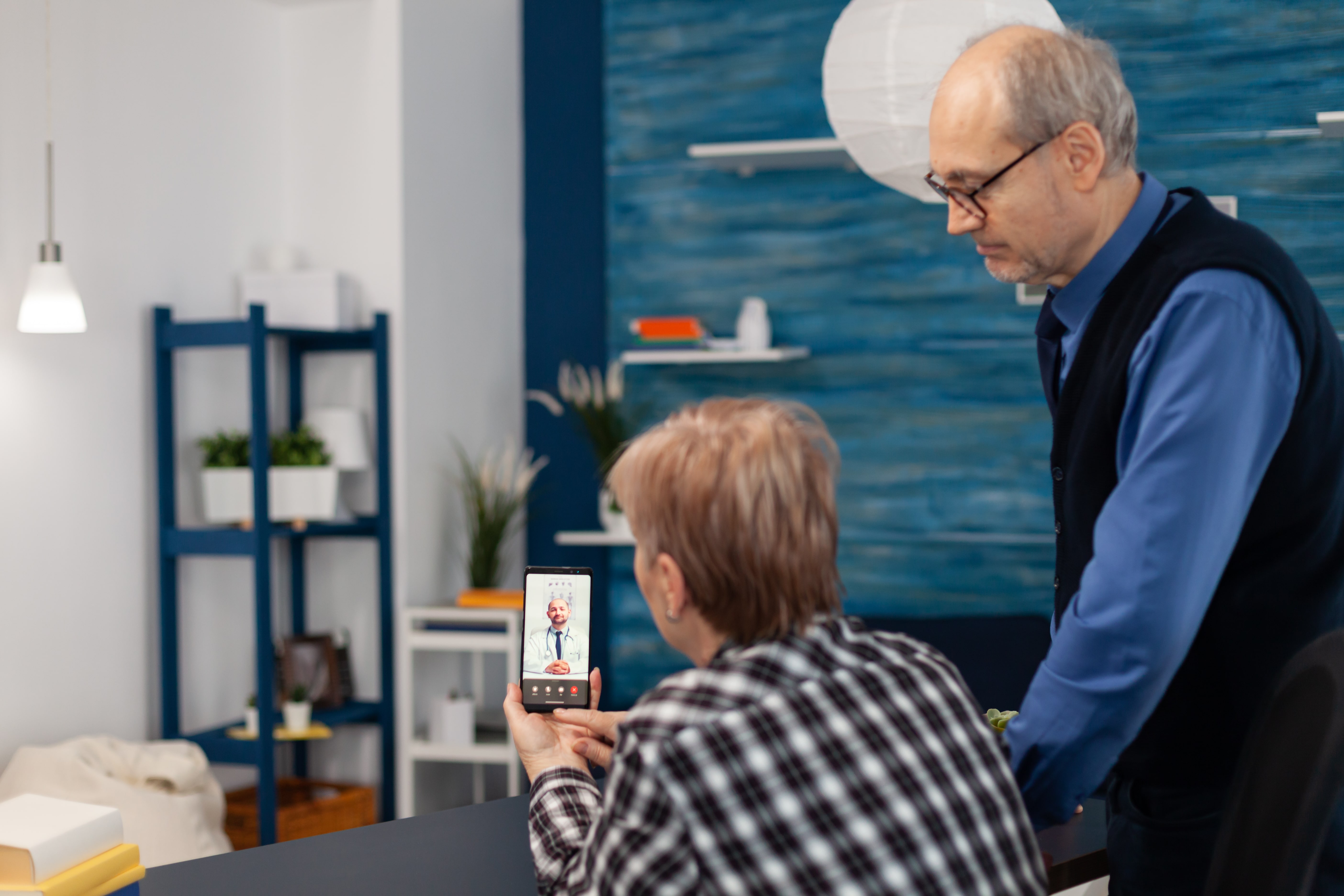 Senior sick man and woman talking with doctor