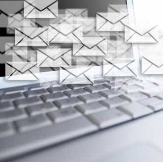 Composite image of close up of laptop put on a desk with letter icons